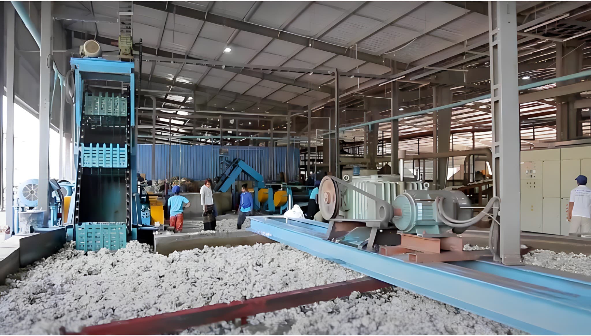 Workers processing crepe rubber inside the factory